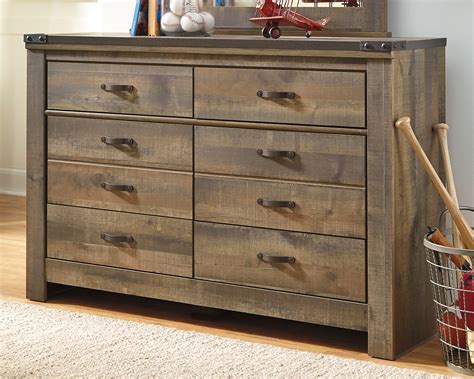 Trinell dresser - Whether she loves horses or he's a cowboy at heart, the Trinell nightstand matches their authenticity. Rustic finish, plank-style details and nailhead trim pay homage to reclaimed barn wood, making for a chic look loaded with charm. ... Trinell 7 Drawer Dresser Item: B446-32 $749.99. Qty * Add to Cart. Out Of Stock. Trinell Queen Panel ...